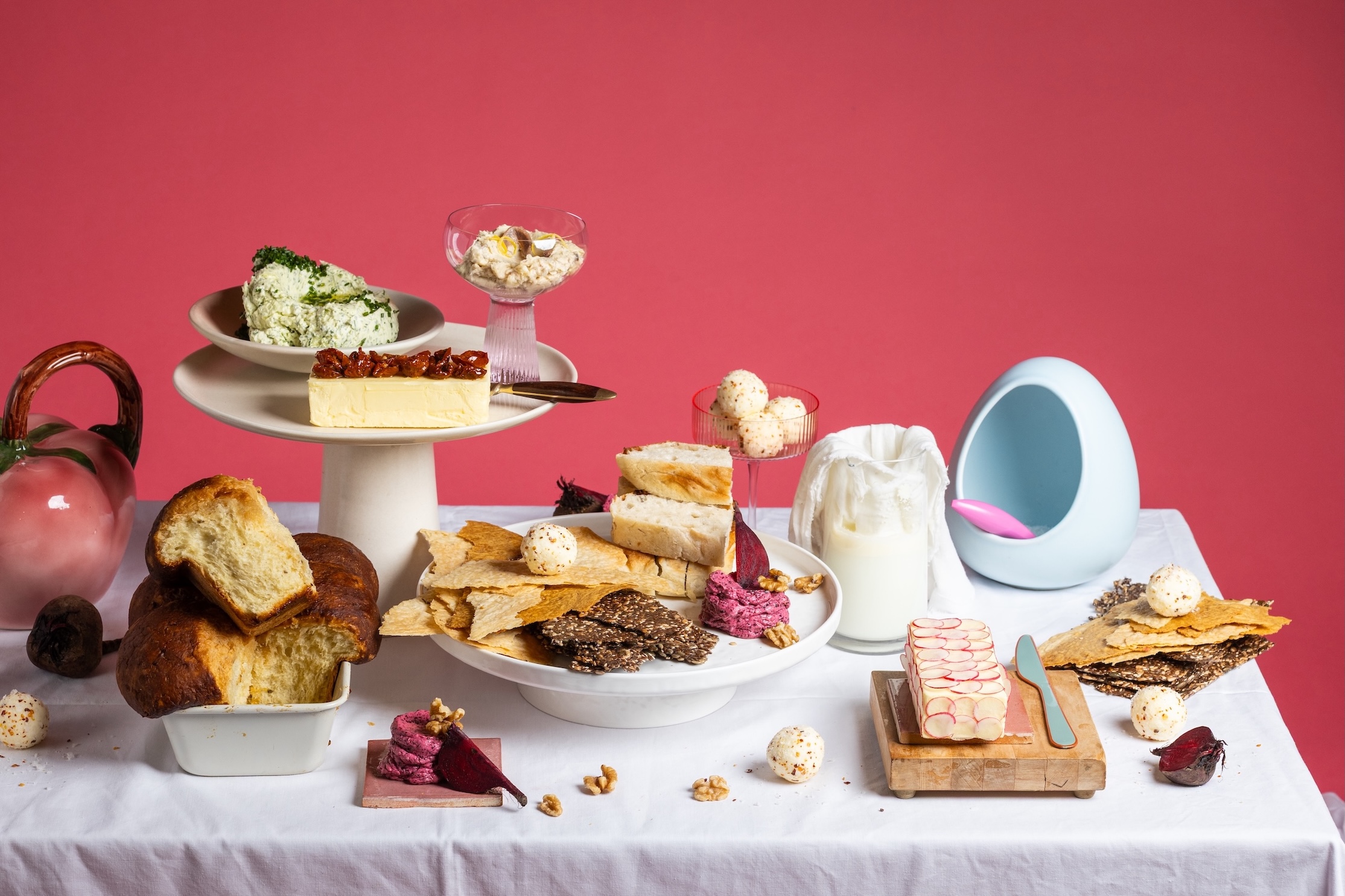 Table spread of butter, dips, bread and crackers with beetroot